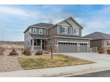 Two-story house with gray siding, landscaped yard, and a two-car garage at 5904 Clover Ridge Cir, Castle Rock, CO 80104