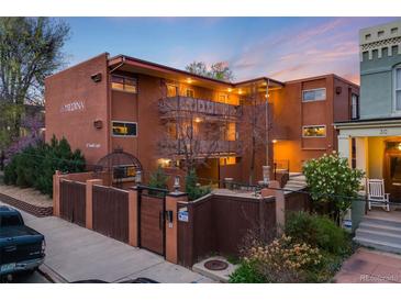 Beautiful multi-Gathering building featuring a gated entrance and well-maintained landscaping at 20 S Logan St # 104, Denver, CO 80209