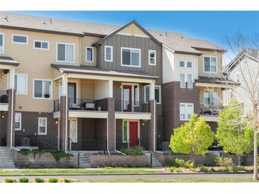 Modern townhome with a blend of brick and siding, featuring a private balcony and inviting curb appeal at 630 E Hinsdale Ave, Littleton, CO 80122