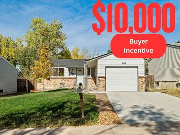 Ranch style home with a well-maintained lawn and attached garage at 17769 E Purdue Pl, Aurora, CO 80013