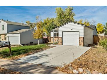 Ranch home with attached garage and landscaped yard at 17769 E Purdue Pl, Aurora, CO 80013