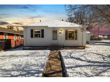 Charming home featuring a quaint front exterior with a walkway and snowy yard at 4100 Fenton St, Denver, CO 80212