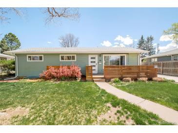Charming green ranch-style house featuring a well-manicured lawn and a welcoming front porch with wooden accents at 1662 S Eudora St, Denver, CO 80222