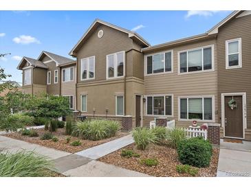 Charming townhome with tidy landscaping, inviting entry, and neutral color palette at 15476 W 64Th Loop # C, Arvada, CO 80007