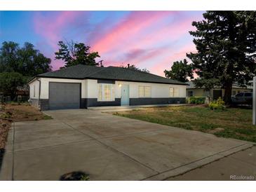 Charming single-story home featuring a gray two-car garage, brick siding, and a well-kept front yard at 1179 Salem St, Aurora, CO 80011