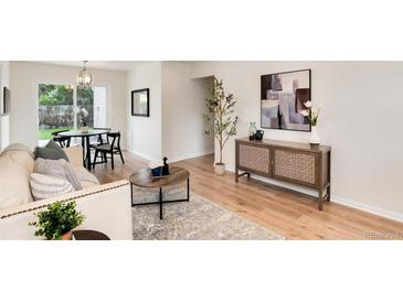 Bright living room featuring modern decor, stylish furniture, and abundant natural light, seamlessly flowing into the dining area at 2986 S Elm St, Denver, CO 80222
