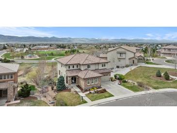 Beautiful two-story home featuring a meticulously landscaped yard and mountain views at 10597 Soulmark Way, Highlands Ranch, CO 80126