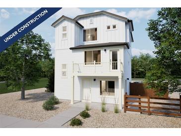 Two-story modern farmhouse-style home with a balcony and fenced yard at 13545 E 103Rd Ave, Commerce City, CO 80022