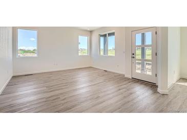 Bright living room boasting of luxury vinyl plank flooring, natural light and modern finishes at 1280 S Algonquian St, Aurora, CO 80018