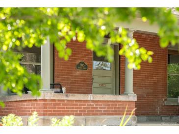 Charming brick home featuring a classic front door and address plaque at 2845 Quitman St, Denver, CO 80212