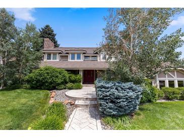 Charming two-story home with mature landscaping and a welcoming front entrance at 7750 S Glencoe Way, Centennial, CO 80122
