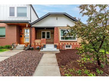 Charming brick home with a cozy front porch and landscaped front yard at 1463 Dahlia St # 2, Denver, CO 80220