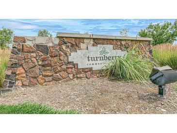 Stone community sign for Turnberry community with inviting landscaping and mailbox at 13392 E 110Th Way, Commerce City, CO 80022