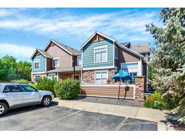 Attractive townhouse with mixed siding, manicured bushes and a convenient parking area at 13271 Holly St # B, Thornton, CO 80241