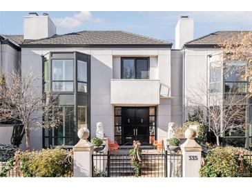 Stunning contemporary home with a black front door and manicured landscaping at 335 Clayton St, Denver, CO 80206