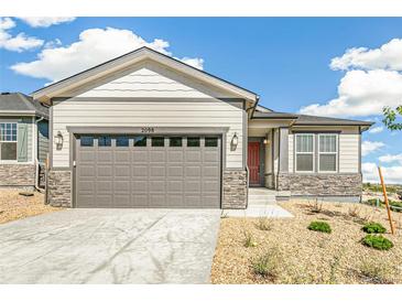 Charming single-story home with neutral siding, stone accents, a gray garage door, and low-maintenance landscaping at 2098 Peachleaf Loop, Castle Rock, CO 80108