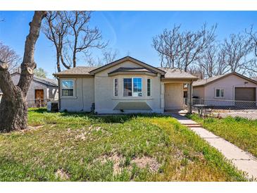 Charming single-story home with a bay window and well-maintained lawn at 4740 Milwaukee St, Denver, CO 80216