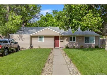 Charming single-story home featuring a well-maintained lawn, inviting walkway, and mature trees at 3278 S Forest St, Denver, CO 80222