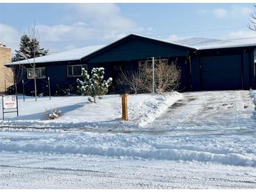 Charming ranch home with dark exterior and snowy front yard at 2960 Ingalls St, Wheat Ridge, CO 80214