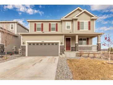 Inviting two-story home with a covered porch and a two car garage and well-maintained landscaping at 3659 Makley Cir, Castle Rock, CO 80104