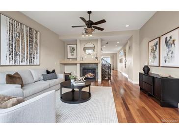 Inviting living room features a fireplace, hardwood floors, and a modern ceiling fan at 3734 Ridgeway St, Boulder, CO 80301
