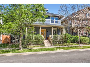Charming two-story home featuring a welcoming front porch and well-manicured lawn in a desirable neighborhood at 3386 Beeler Ct, Denver, CO 80238