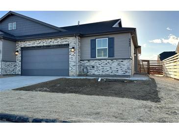 Beautiful single Gathering home featuring stone and siding, a two car garage, and professional landscaping at 3441 N Denali St, Aurora, CO 80019