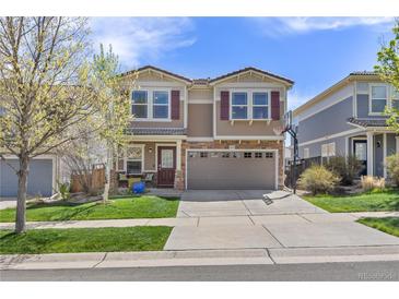 Two-story home showcasing great curb appeal, a two-car garage, and manicured lawn at 2410 Morningview Ln, Castle Rock, CO 80109