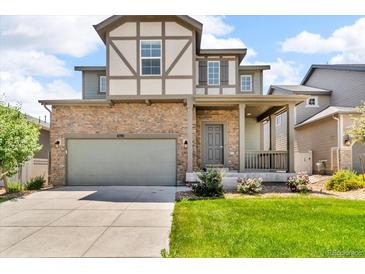 Charming two-story home showcasing a stone facade, a two-car garage, and a welcoming front porch with a manicured lawn at 6591 N Ceylon St, Denver, CO 80249