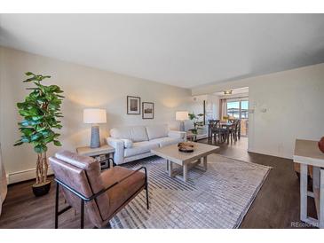 Living room with gray couch, brown armchair, and dining area at 3734 Miller Ct, Wheat Ridge, CO 80033