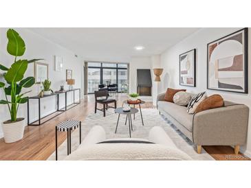 Bright living room with hardwood floors, modern furniture, and city views at 1777 Larimer St # 2209, Denver, CO 80202