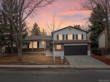 Charming two-story home with brick accents and a well-maintained front yard, perfect for suburban living at 1643 S Fairplay St, Aurora, CO 80012