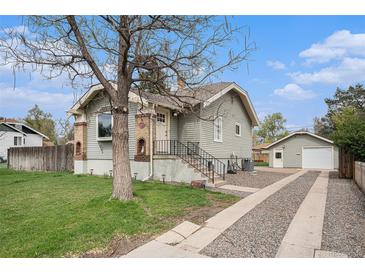 Charming home with new siding, a detached garage, and a gravel driveway at 2272 Jay St, Edgewater, CO 80214