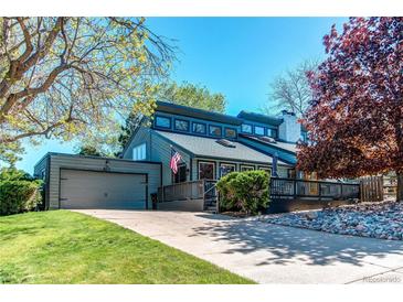 Charming home featuring a modern design, attached garage, and a well-maintained lawn, perfect for suburban living at 8277 Carriage Ln, Parker, CO 80134