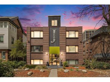 Charming brick apartment building with unique facade details and manicured landscaping at 1977 S Josephine St # 101, Denver, CO 80210