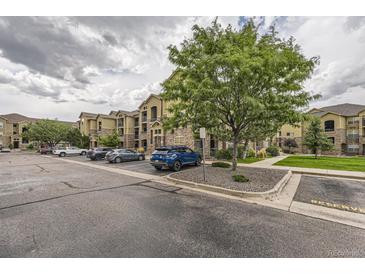 Attractive apartment complex featuring stone accents, well-maintained landscaping, and convenient parking at 9180 Rolling Way # 303, Parker, CO 80134