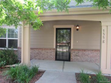 Inviting front porch with a secure screen door and well-maintained landscaping adding curb appeal at 555 Alton Way # E, Denver, CO 80230