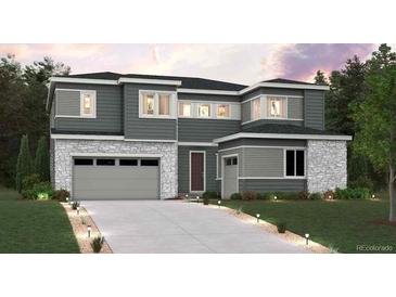 Beautiful two-story home with a gray exterior, stone accents, and well-maintained landscaping at 1727 Morgan Dr, Erie, CO 80516