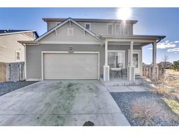 Charming gray two-story home with a two-car garage and inviting front porch at 13464 E 107Th Ave, Commerce City, CO 80022