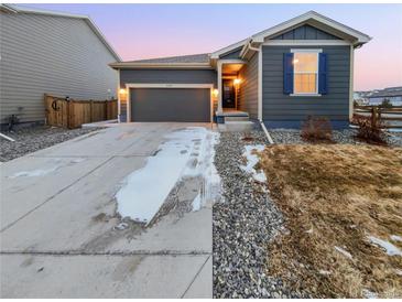 Charming single-story home with a well-maintained lawn and a two-car garage at 27699 E 7Th Ln, Aurora, CO 80018