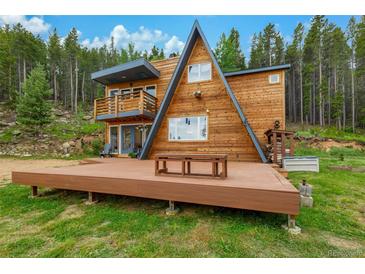 Stunning A-frame home with a large deck and a forest backdrop at 509 Paiute Rd, Evergreen, CO 80439