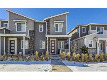 Modern two-story home with gray siding and a landscaped front yard at 9643 Truckee St, Commerce City, CO 80022