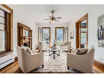 Cozy living room featuring a fireplace, plush seating, and balcony access for seamless indoor-outdoor living at 1284 N Corona St # B6, Denver, CO 80218