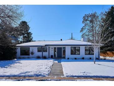 Stunning white brick ranch home with a landscaped yard and walkway at 625 S Monroe Way, Denver, CO 80209