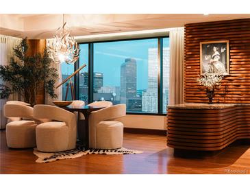 Elegant dining room with city views, a unique chandelier, and stylish decor at 1133 14Th St # 3420, Denver, CO 80202