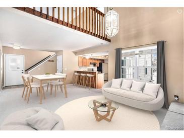 Bright living room featuring hardwood floors, vaulted ceilings, modern furnishings, and a view into the kitchen at 2141 S Victor St # B, Aurora, CO 80014