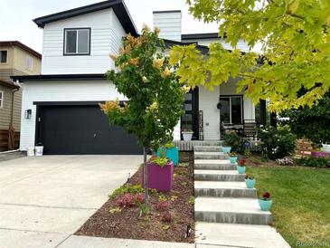 Two-story home with modern exterior, landscaping, and welcoming front porch at 17826 E 107Th Way, Commerce City, CO 80022