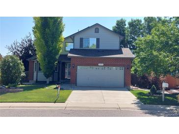 Charming two-story home with well-maintained lawn and a two car garage at 14558 Vine St, Thornton, CO 80602