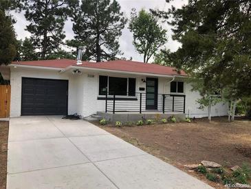 Charming exterior featuring a painted brick facade, modern black accents, and a well-maintained front yard at 3338 W Arlington Ave, Littleton, CO 80123