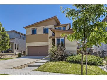 Two-story home featuring a two-car garage, neutral siding, and well-maintained landscaping at 10808 Salida St, Commerce City, CO 80022